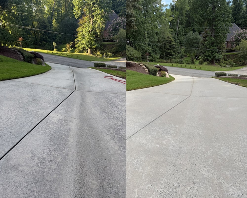 Before and after: a stained concrete driveway pressure-washed from grey back to bright by KM Property Restorations