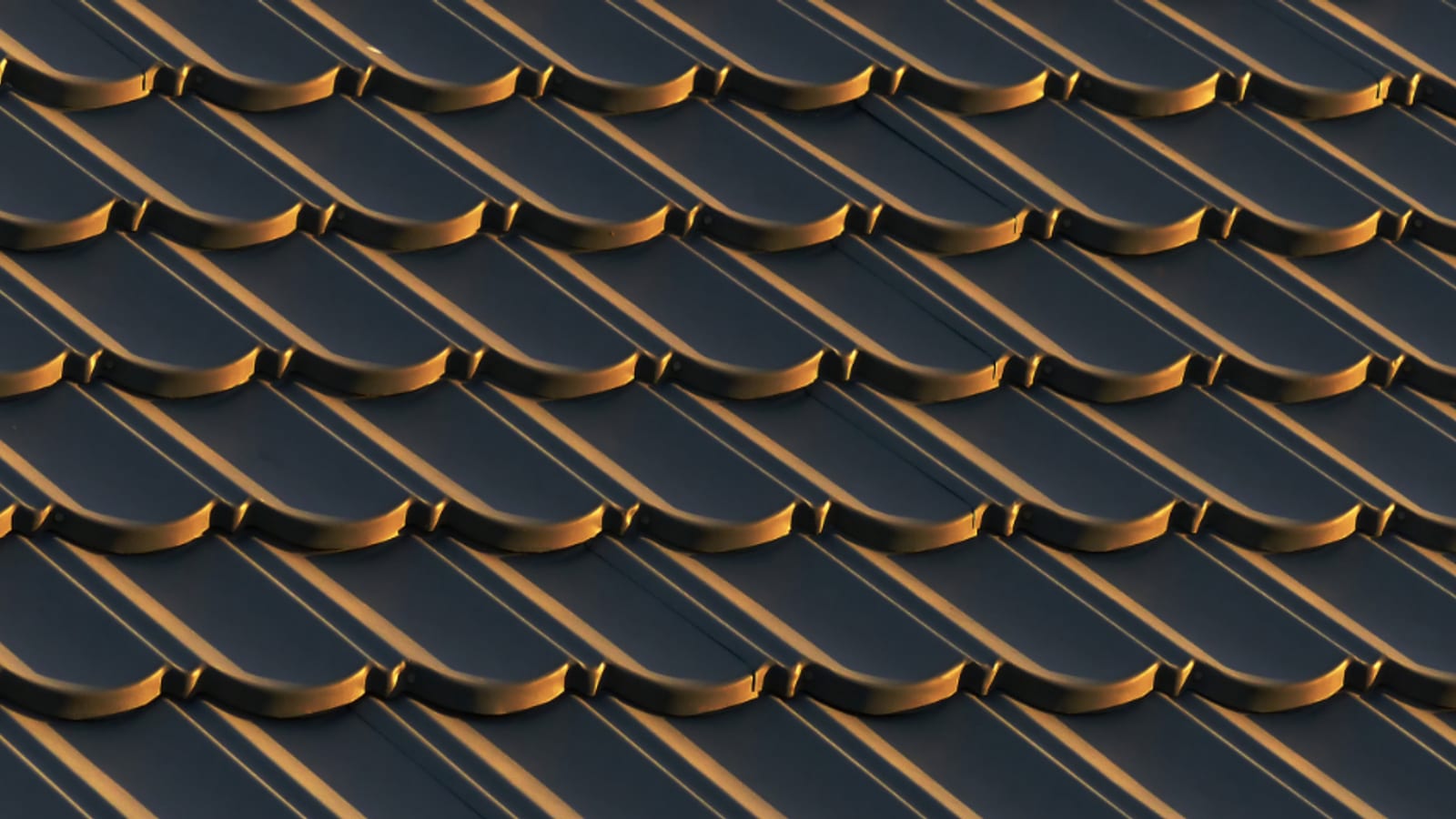 Close macro of clean roof tiles catching warm light