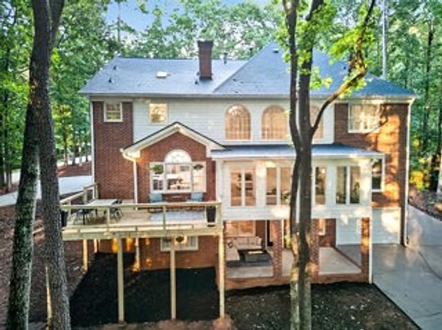 A large home rear exterior and deck cleaned by KM Property Restorations
